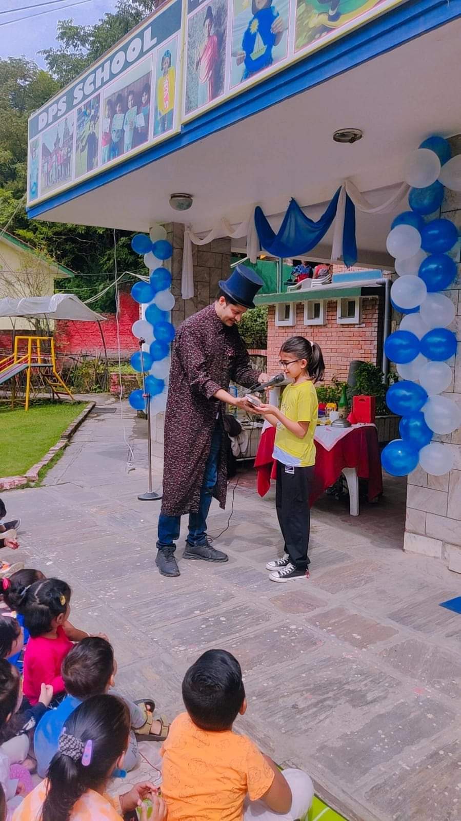 Koirala Sarkar performing with a young volunteer